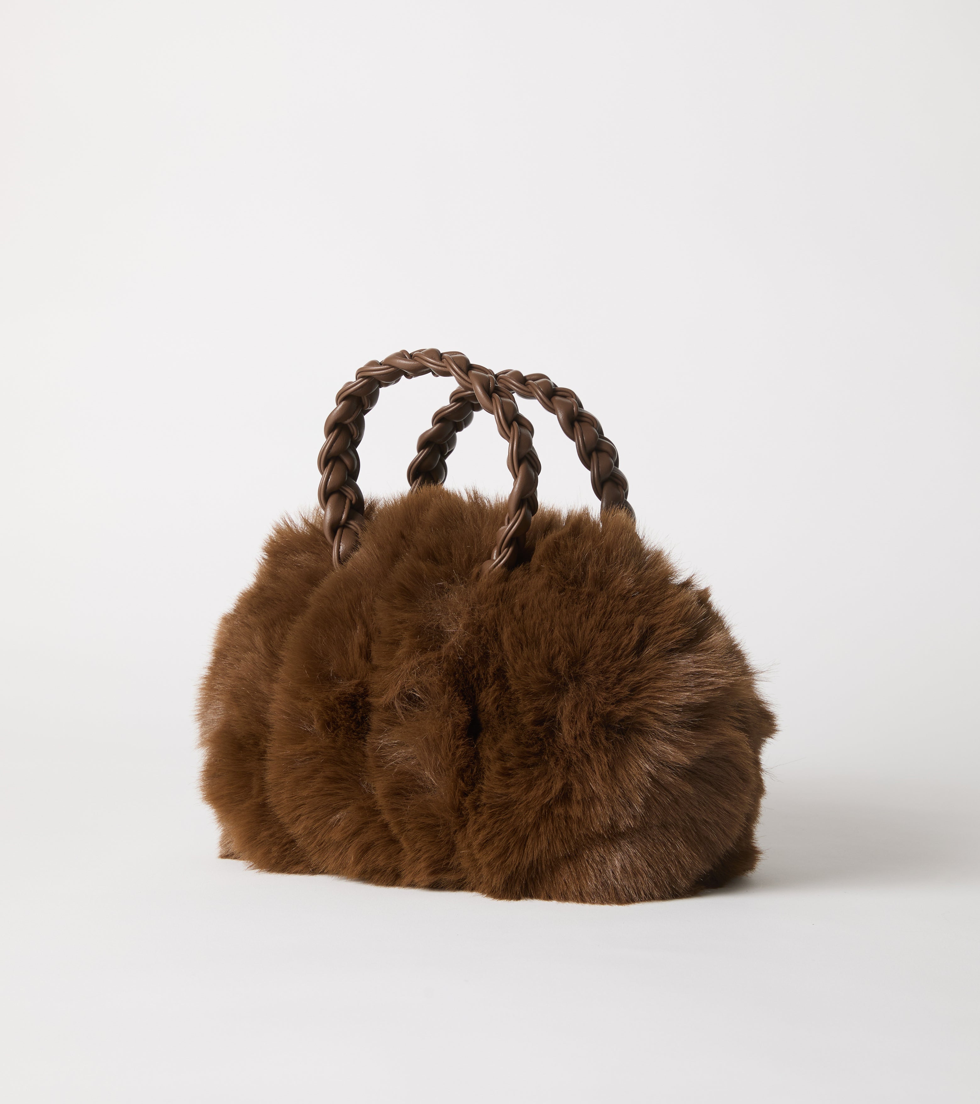 Faux fur bag with woven handles